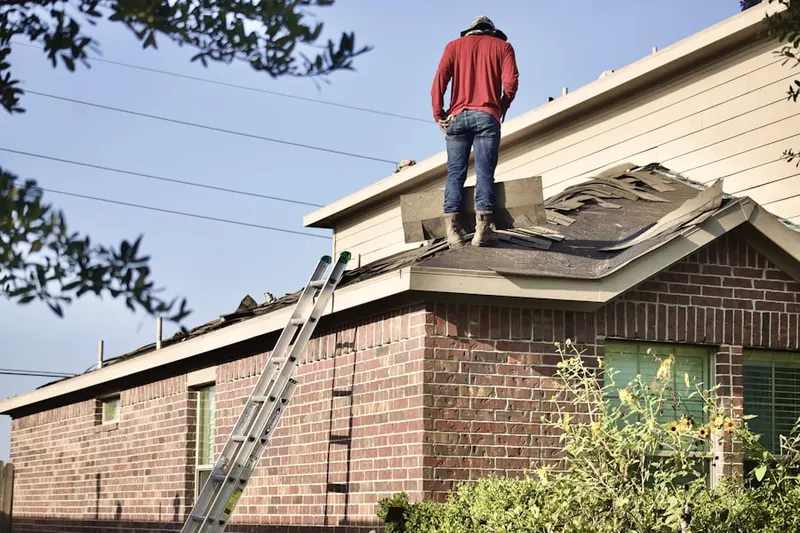 Professional roofer working on a residential roof in Lake Charles
